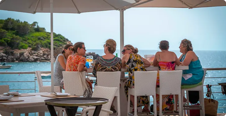 Friends having lunch on the seafront terrace